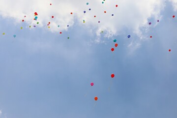 balloons flight in the blue sky during the party