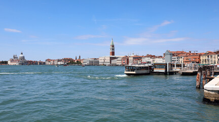 vaporetti of the island of VENICE in Italy with the bell tower of san marco and the ducal palace and very few boats during the lockdown