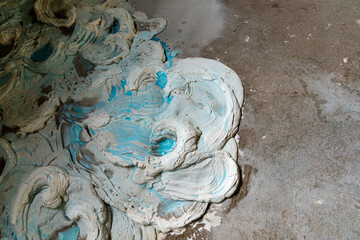 A lot of blue and white gypsum poured out on the floor