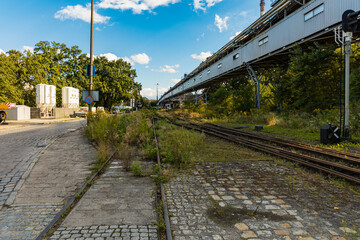Long rails at old unused factory square next to long bridge