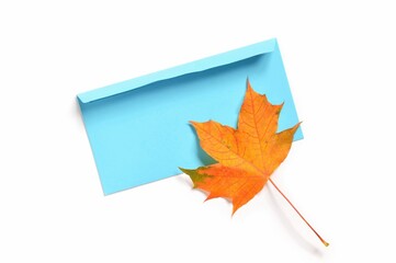 Blue paper envelope and maple leaf flat lay photography isolated on a white background. Stylish autumn mockup for design
