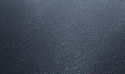 many small drops of water on a black metal background,