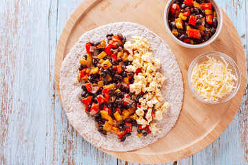 Beans and egg burritos with vegetables with whole-wheat tortillas