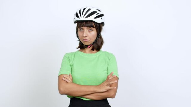 Young woman with bike helmet over isolated background looking side over isolated background