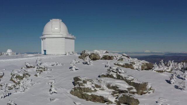 Aerial footage of snowy astronomical observatory in Calar Alto after snowfall , Sierra de los Filabres, Almeria, Spain