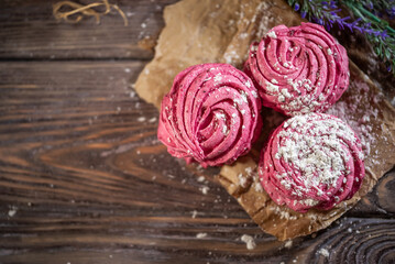 Fresh pink zephyr marshmallow on a wooden rustic background