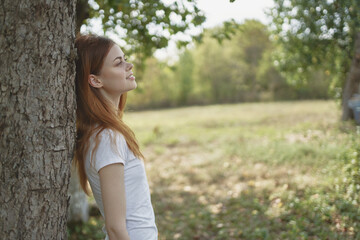 cheerful woman near the tree nature Lifestyle summer