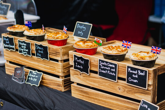 Pies and food being sold at a market in the UK with British English flags