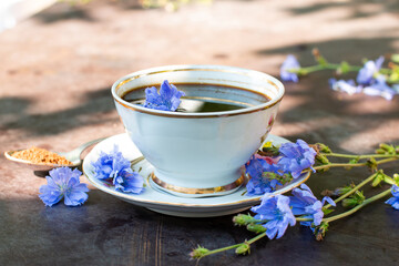 Diet drink chicory in a cup - coffee substitutes, powder and fowers. Selective focus