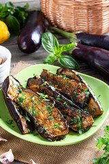 Appetizer from eggplant in honey with chili parsley and lemon on a table