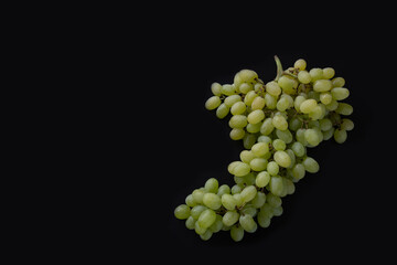 Green grapes on a dark background 