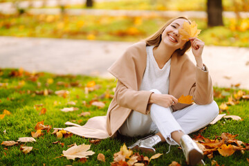 Young woman resting in nature. People, relaxation and vacations concept. Autumn style.