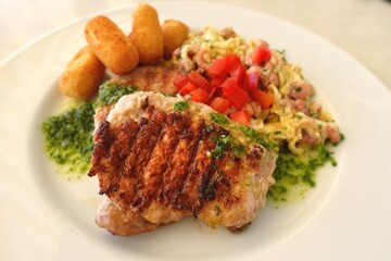 Grilled meat with scrambled eggs and potato 