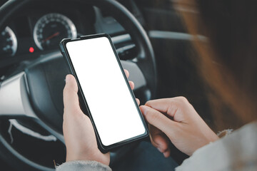 Asian woman sitting in a car using mobile phone with blank screen, video calling, online...