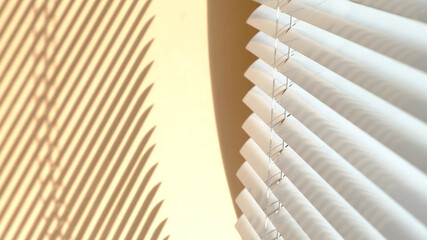 Window with open modern horizontal blinds indoors. The sunlight shines through the venetian blinds,...
