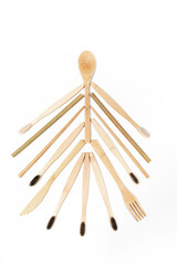 Eco friendly natural bamboo toothbrushes and wooden cutlery laid out as Christmas tree on white. Vertical orientation.