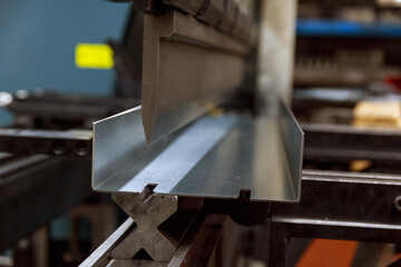 The process of bending metal parts on a modern bending machine. Long metal parts made of thin...