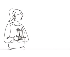 Single one line drawing woman holding glass with delicious milkshake. Young girl holding tasty fresh milk shake with slice of orange. Modern continuous line draw design graphic vector illustration