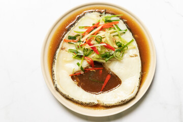 Steamed snow fish with soy sauce. Snow fish, soy sauce, ginger, scallion and chili. Top view on white table background.