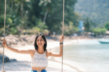 woman on the beach, clear water sea with blue sky on the Holiday, palm tree beach, at Haad Chaloklum beach, koh phangan island,suratthani , thailand