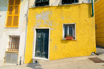 Traditional colors of the house, walls, doors, windows. Italy. - 459276401
