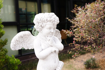 White angel statue decorate in garden , little angel sculpture decorate in home garden