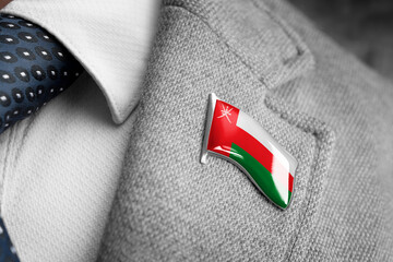 Metal badge with the flag of Oman on a suit lapel