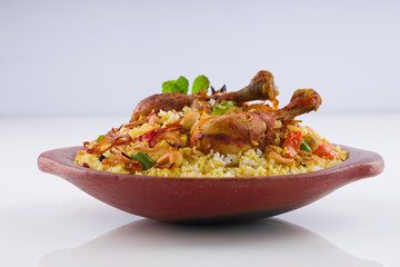 Chicken biryani , kerala style chicken dhum biriyani made using jeera rice and spices arranged in  earthen ware  on white background, isolated