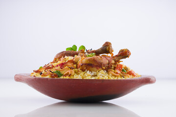 Chicken biryani , kerala style chicken dhum biriyani made using jeera rice and spices arranged in  earthen ware  on white background, isolated
