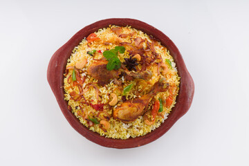 Chicken biryani , kerala style chicken dhum biriyani made using jeera rice and spices arranged in  earthen ware  on white background, isolated