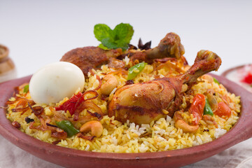 Chicken biryani , kerala style chicken dhum biriyani made using jeera rice and spices arranged in ...