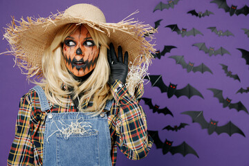 Young woman with Halloween makeup mask wear straw hat scarecrow costume try to hear you overhear...