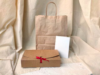 Gift wrapping mockup. Craft bag, craft gift box and postcard