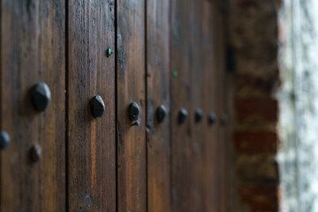 Medieval wooden door with decorative metal fittings.