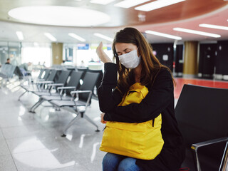 woman with closed eyes medical mask waiting Passenger with luggage