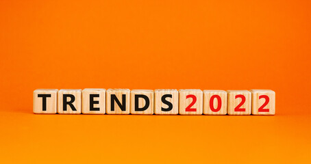 Business concept of 2022 trends symbol. Words 'Trends 2022' on wooden cubes. Beautiful orange table, orange background. Business and trends 2021 new year concept. Copy space.