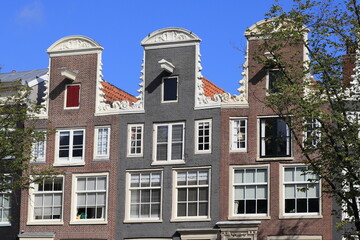 Fototapeta na wymiar Amsterdam Traditional Canal House Facades Close Up with Decorated Neck Gables, Netherlands