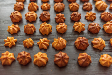 Delicious homemade organic eclairs laid out in a row on a wooden surface.