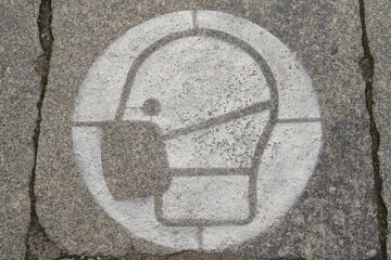 head with mask painted in white on the street