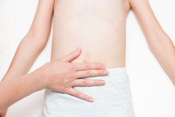 The surgeon examines the patient's abdominal cavity for the presence of an umbilical hernia. The...