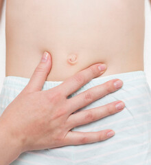 The surgeon examines the patient's abdominal cavity for the presence of an umbilical hernia. The concept of an abdominal wall disease with an umbilical hernia. Stomach pain.