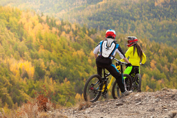 cyclists enjoy the autumn forest landscape at the top of the mountain