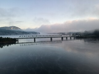 A bridge over water with a foggy sunrise. Bridge is on Lake Allatoona in Cartersville