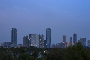 Urban skyscrapers under the rosy sky at nightfall;