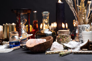 Witchcraft table set, selective focus. Alchemy and esoteric symbol items for magic cult. Spiritual occultism and magic chemistry inspired by mysticism. Witch and warlock magician concept. Halloween.
