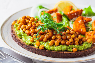 Toast with guacamole and crispy chickpeas, close-up.