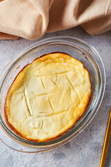 Delicious cottage cheese casserole in portioned glass forms with sour cream. Traditional Russian cuisine for breakfast - Zapekanka