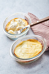 Delicious cottage cheese casserole in portioned glass forms with sour cream. Traditional Russian cuisine for breakfast - Zapekanka