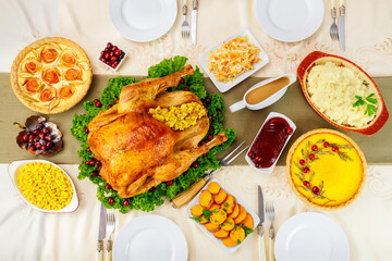 Thanksgiving dinner setting. Stuffed turkey with traditional dishes.