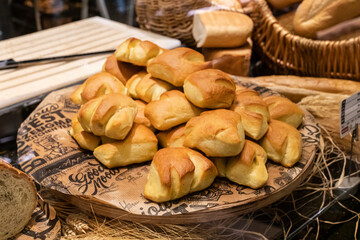fresh sweet golden shaped buns on a tray in the bakery on the window. fresh pastries, small business